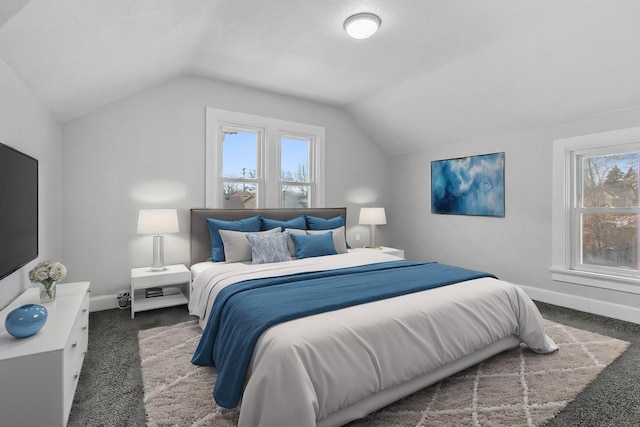 bedroom featuring dark carpet and vaulted ceiling