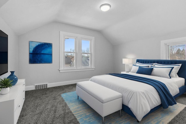 carpeted bedroom with vaulted ceiling and multiple windows