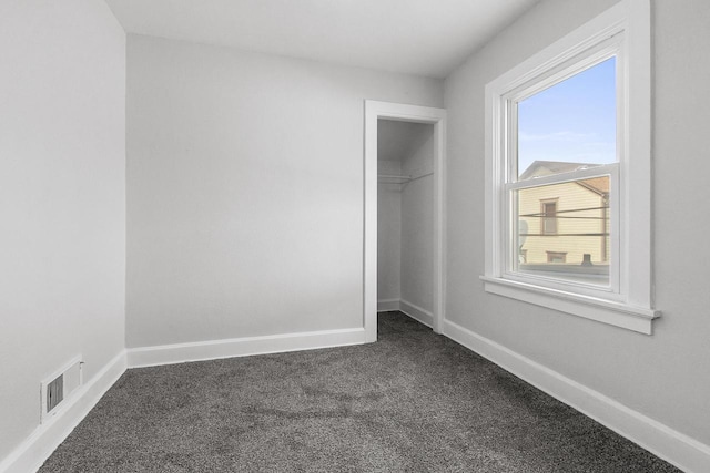 unfurnished bedroom with a closet and carpet