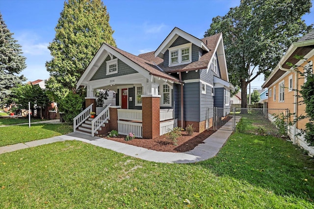 view of front of home with a porch and a front yard