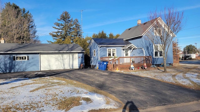 view of front of house featuring a garage and a wooden deck