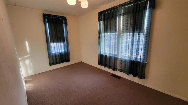 carpeted empty room with crown molding