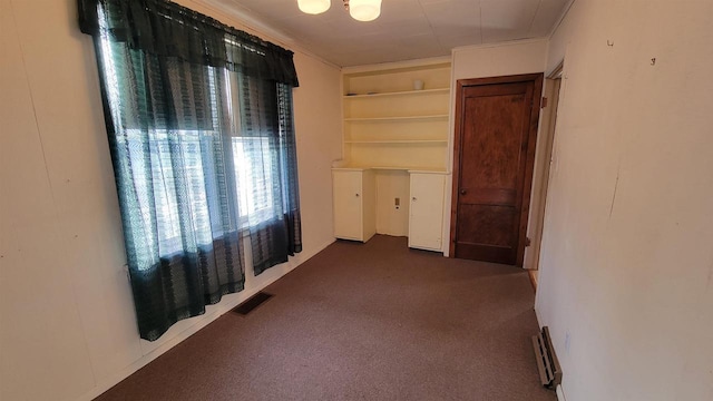 carpeted empty room featuring ornamental molding