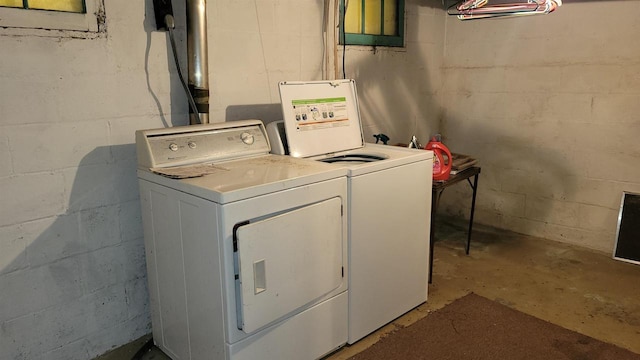 clothes washing area featuring washer and dryer