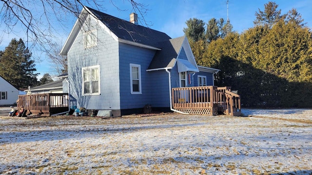 view of home's exterior with a wooden deck