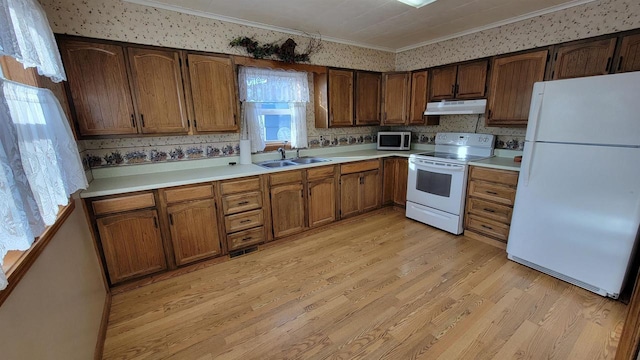 kitchen featuring crown molding, white appliances, sink, and light wood-type flooring