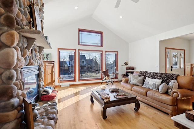 2743 Brooks Ridge Dr, Sun Prairie, WI 53590 - living room featuring ceiling fan, lofted ceiling, a fireplace, and light wood-type flooring
