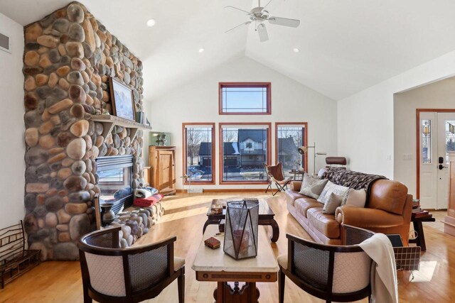 2743 Brooks Ridge Dr, Sun Prairie, WI 53590 - living room with vaulted ceiling, ceiling fan, a fireplace, and light wood-type flooring