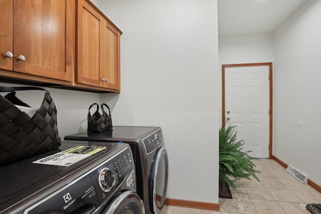 2743 Brooks Ridge Dr, Sun Prairie, WI 53590 - clothes washing area with cabinets, light tile patterned floors, and independent washer and dryer
