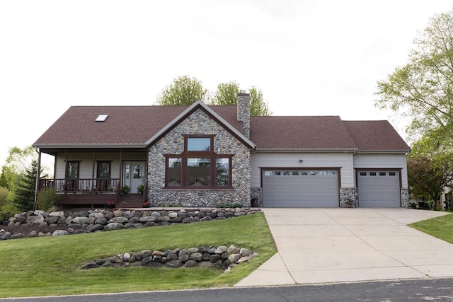 view of front facade featuring a garage, covered porch, and a front lawn