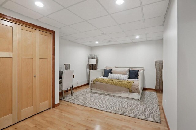 2743 Brooks Ridge Dr, Sun Prairie, WI 53590 - bedroom featuring a drop ceiling, light hardwood / wood-style flooring, and a closet