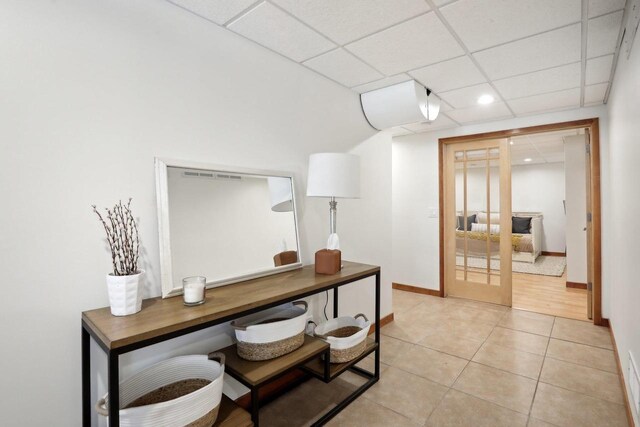 2743 Brooks Ridge Dr, Sun Prairie, WI 53590 - hallway with french doors, a paneled ceiling, and tile patterned flooring