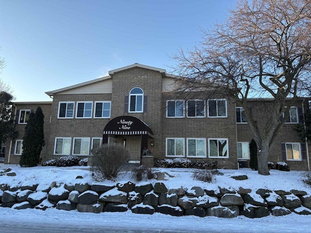 view of front of house featuring brick siding and central air condition unit