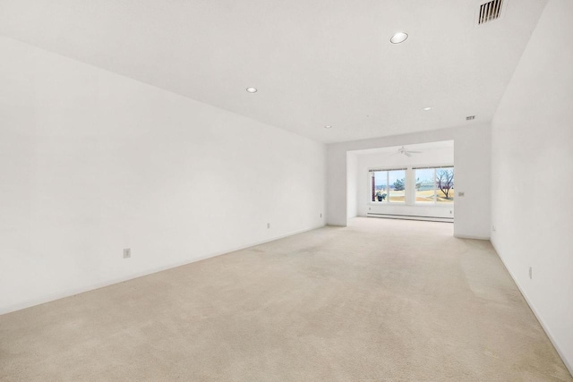 unfurnished room with light carpet, visible vents, and recessed lighting