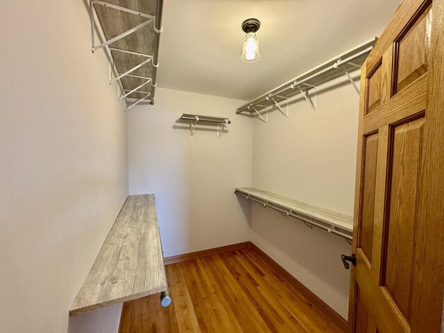 spacious closet featuring hardwood / wood-style floors