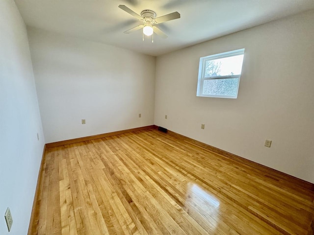 spare room featuring light hardwood / wood-style floors and ceiling fan