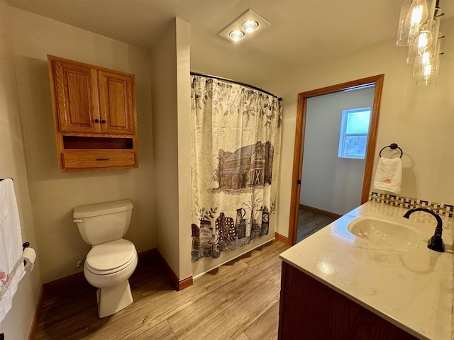 bathroom featuring hardwood / wood-style flooring, vanity, and toilet