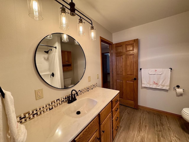 bathroom featuring hardwood / wood-style flooring, vanity, and toilet