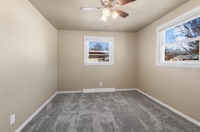 carpeted spare room with ceiling fan