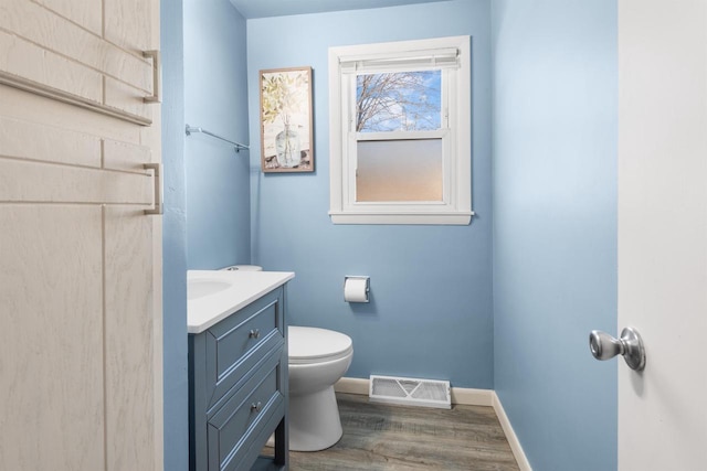 bathroom with vanity, hardwood / wood-style floors, and toilet