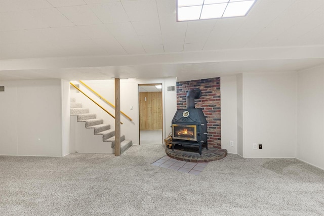 basement featuring a wood stove and carpet