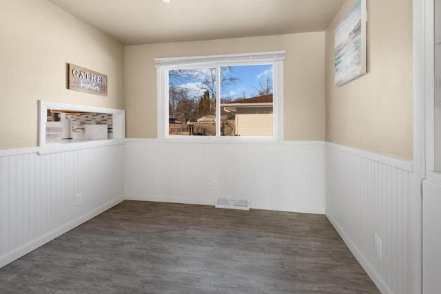 spare room with dark hardwood / wood-style flooring