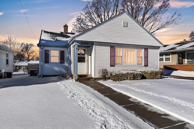 bungalow-style house with central AC unit