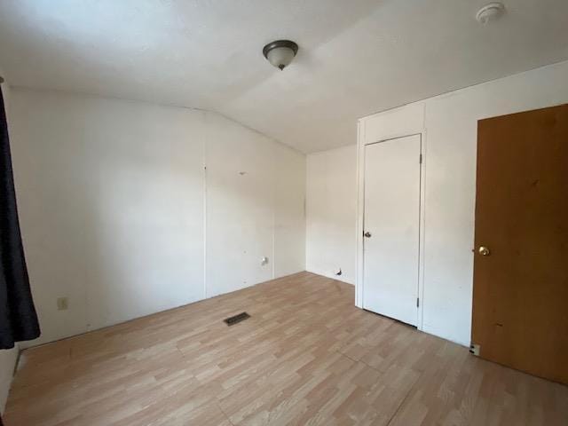 interior space featuring vaulted ceiling and light hardwood / wood-style flooring