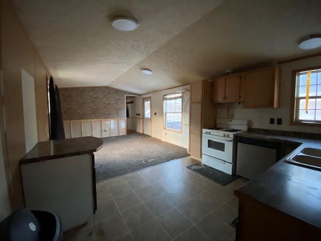 kitchen featuring lofted ceiling, sink, and white gas range oven