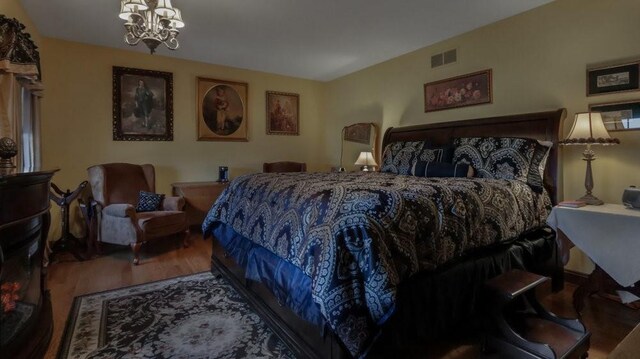 N3684 Claire Rd, Taylor, WI 54659 - bedroom with an inviting chandelier and hardwood / wood-style floors
