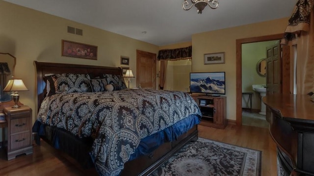 N3684 Claire Rd, Taylor, WI 54659 - bedroom featuring ensuite bath and wood-type flooring