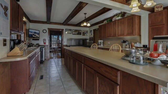 N3684 Claire Rd, Taylor, WI 54659 - kitchen featuring sink, a chandelier, light tile patterned floors, pendant lighting, and beam ceiling