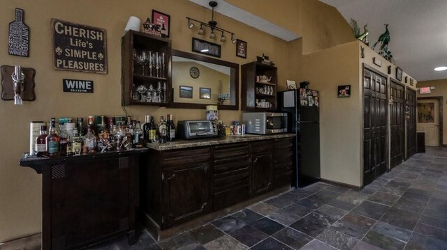 N3684 Claire Rd, Taylor, WI 54659 - bar featuring black refrigerator and dark brown cabinetry