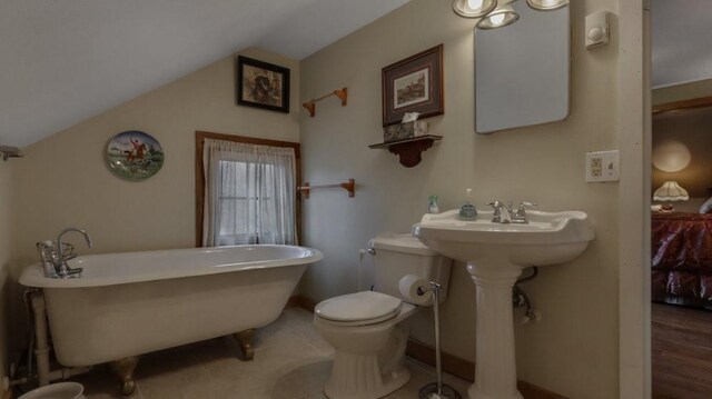 N3684 Claire Rd, Taylor, WI 54659 - bathroom featuring a bathing tub, vaulted ceiling, and toilet