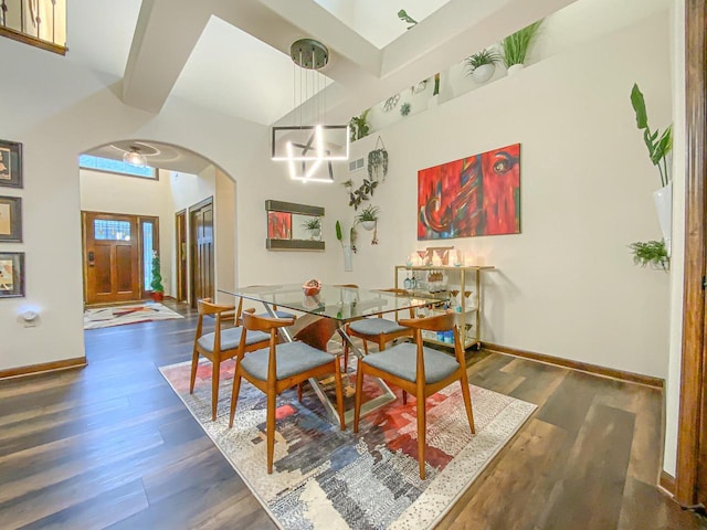 dining space featuring an inviting chandelier and dark wood-type flooring