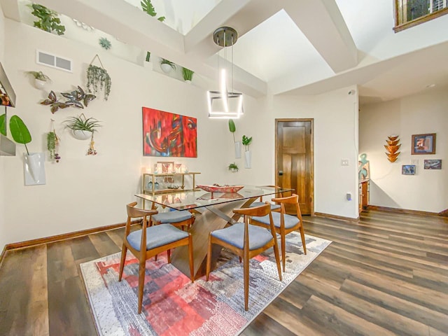 dining space featuring a wall mounted air conditioner and dark hardwood / wood-style floors