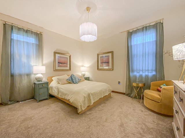 bedroom featuring light colored carpet