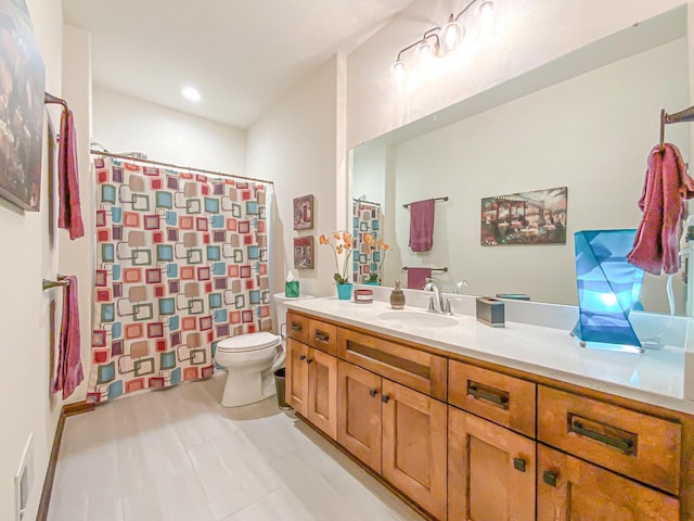 bathroom featuring vanity, toilet, and a shower with shower curtain