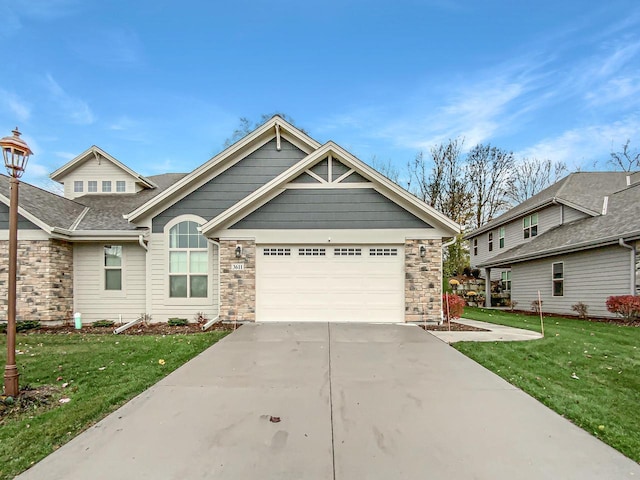 craftsman-style home featuring a garage and a front lawn