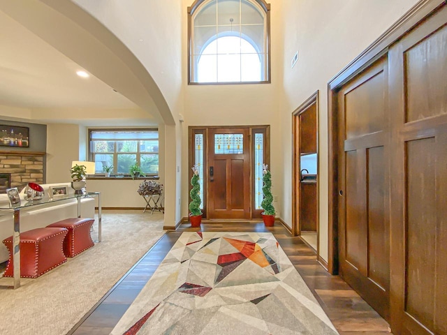 entryway with dark hardwood / wood-style flooring and a high ceiling