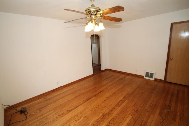 empty room with hardwood / wood-style floors and ceiling fan