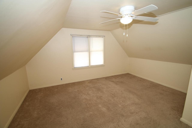 additional living space featuring vaulted ceiling, ceiling fan, and carpet