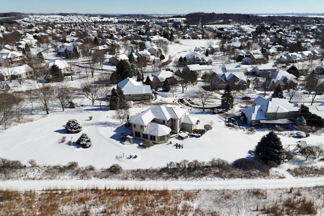 snowy aerial view featuring a residential view