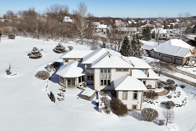 snowy aerial view with a residential view