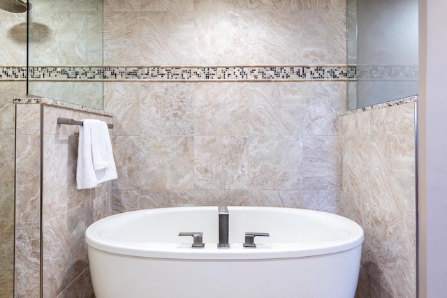 bathroom featuring a soaking tub and tile walls