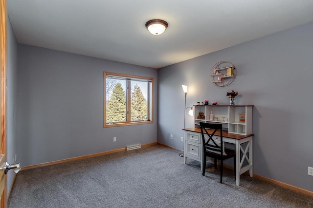 office area with carpet flooring, visible vents, and baseboards