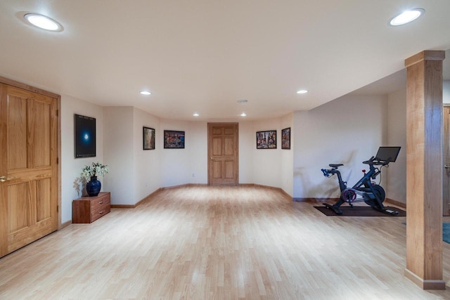 workout room featuring light wood-type flooring, baseboards, and recessed lighting