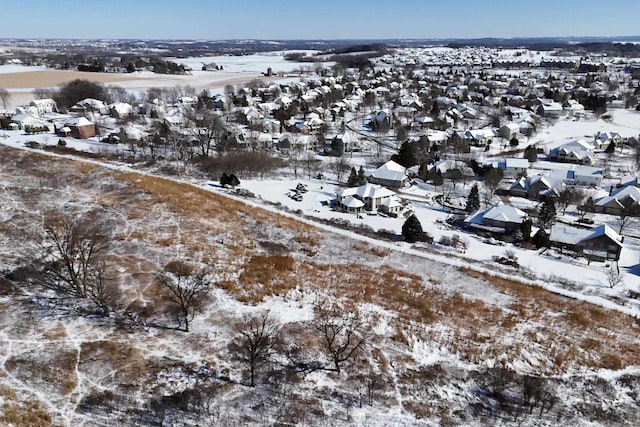 snowy aerial view featuring a residential view