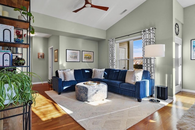 living room featuring hardwood / wood-style flooring, vaulted ceiling, and ceiling fan