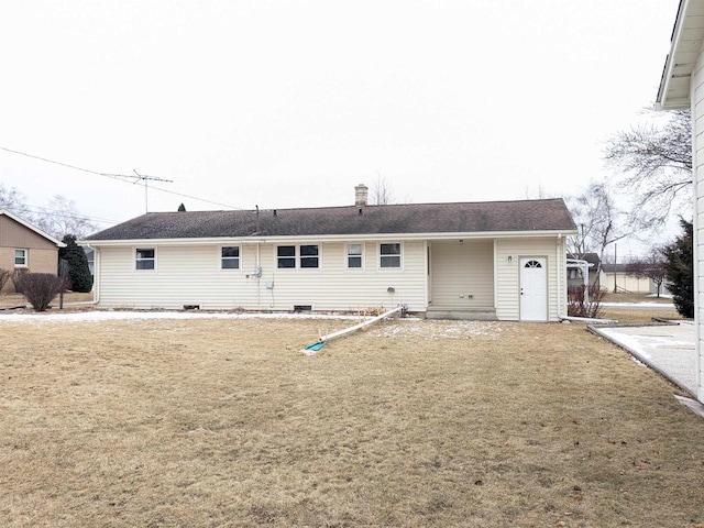 rear view of house featuring a yard